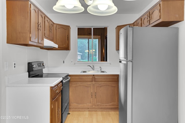 24 Ironside Dr Unit B, Whiting, NJ 08759 - kitchen with freestanding refrigerator, electric range, under cabinet range hood, light countertops, and brown cabinetry