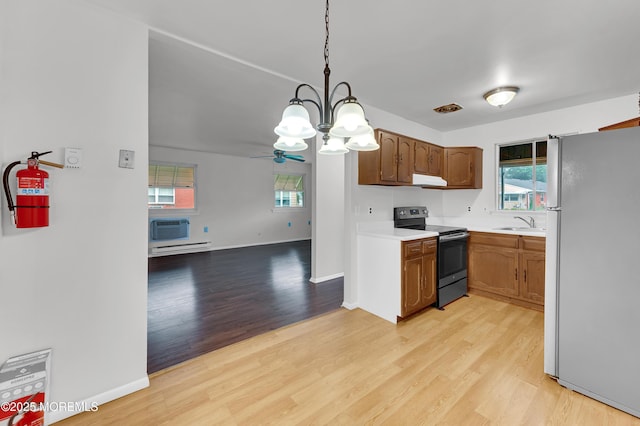 24 Ironside Dr Unit B, Whiting, NJ 08759 - kitchen featuring stainless steel electric range oven, freestanding refrigerator, light countertops, light wood-type flooring, and a chandelier