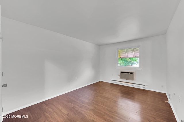24 Ironside Dr Unit B, Whiting, NJ 08759 - unfurnished room with baseboard heating, wood finished floors, and a wall mounted air conditioner