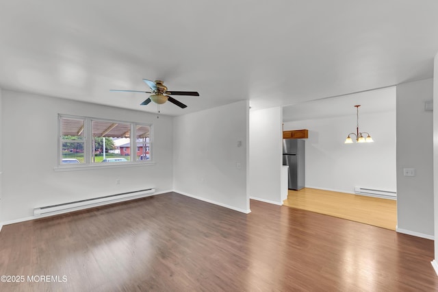 24 Ironside Dr Unit B, Whiting, NJ 08759 - unfurnished living room featuring a baseboard heating unit, a chandelier, a ceiling fan, and wood finished floors