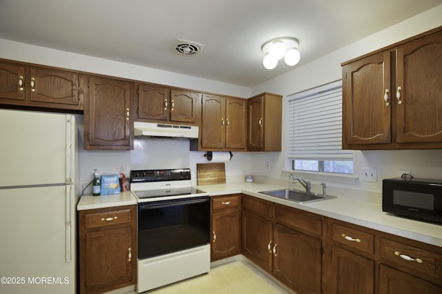 6 Lincoln Ct, Whiting, NJ 08759 - kitchen with freestanding refrigerator, electric range oven, under cabinet range hood, black microwave, and light countertops