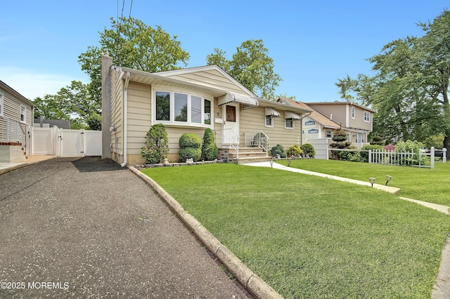 72 1st Ave, Port Reading, NJ 07064 - bungalow-style house featuring a gate, driveway, and a chimney
