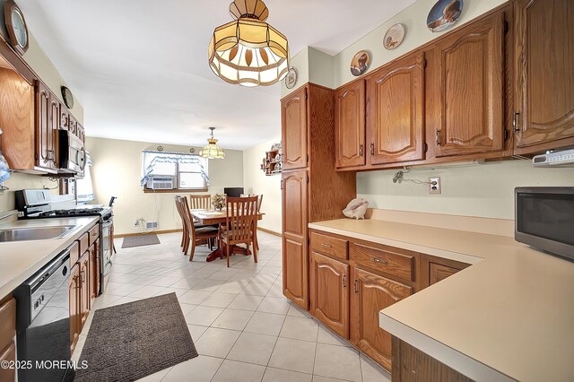72 1st Ave, Port Reading, NJ 07064 - kitchen featuring stainless steel appliances, brown cabinets, light countertops, hanging light fixtures, and light tile patterned flooring