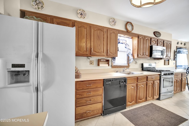 72 1st Ave, Port Reading, NJ 07064 - kitchen featuring appliances with stainless steel finishes, light tile patterned floors, light countertops, and brown cabinetry