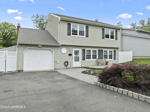 6 Convent Ct, Hazlet, NJ 07730 - colonial-style house featuring a garage, a chimney, asphalt driveway, and a shingled roof