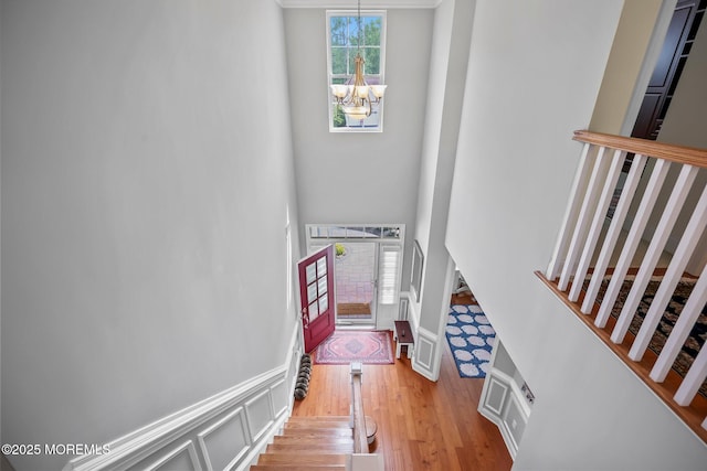 86 Legacy Ct, Freehold, NJ 07728 - stairway featuring a chandelier, wood finished floors, and a high ceiling