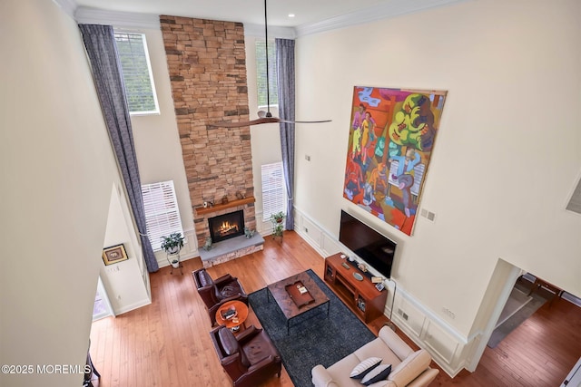86 Legacy Ct, Freehold, NJ 07728 - living area featuring a fireplace, hardwood / wood-style floors, ornamental molding, and a towering ceiling