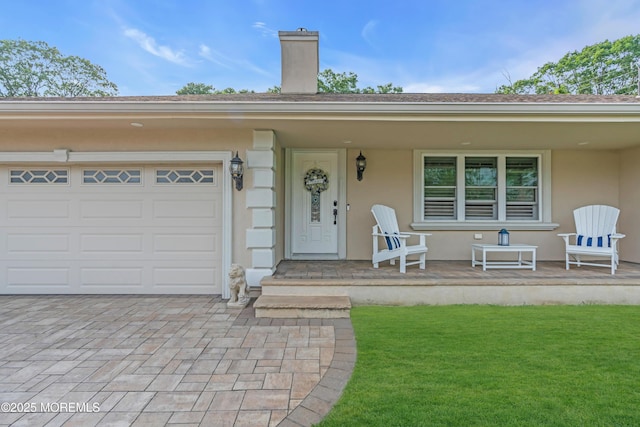 18 Pinewood Dr, Brick, NJ 08724 - view of exterior entry with a chimney, a yard, stucco siding, and a porch