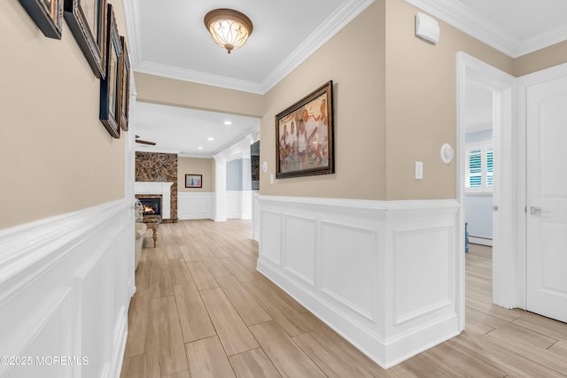 18 Pinewood Dr, Brick, NJ 08724 - hallway with crown molding, light wood-style flooring, a wainscoted wall, a baseboard radiator, and a decorative wall