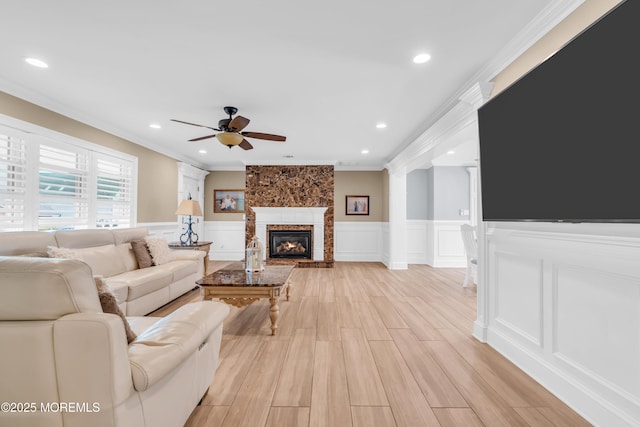 18 Pinewood Dr, Brick, NJ 08724 - living room featuring crown molding, ceiling fan, a decorative wall, a wainscoted wall, and a large fireplace