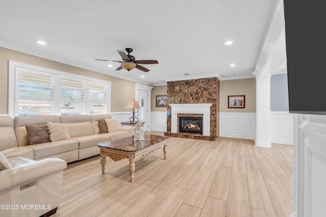 18 Pinewood Dr, Brick, NJ 08724 - living area with a ceiling fan, crown molding, a wainscoted wall, a decorative wall, and a large fireplace