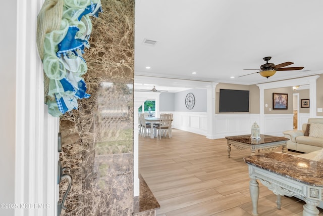 18 Pinewood Dr, Brick, NJ 08724 - living area with a ceiling fan, wainscoting, ornamental molding, a decorative wall, and light wood-style flooring