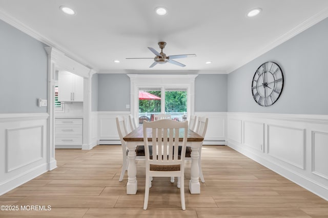 18 Pinewood Dr, Brick, NJ 08724 - dining space with a decorative wall, a ceiling fan, crown molding, wainscoting, and a baseboard radiator