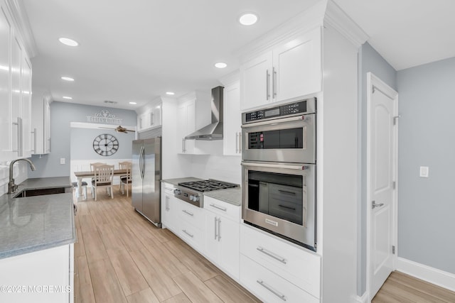18 Pinewood Dr, Brick, NJ 08724 - kitchen featuring stainless steel appliances, wall chimney exhaust hood, light wood-style floors, white cabinets, and recessed lighting