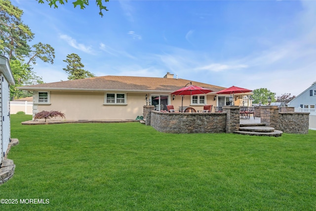 18 Pinewood Dr, Brick, NJ 08724 - back of house featuring a lawn, a chimney, and stucco siding