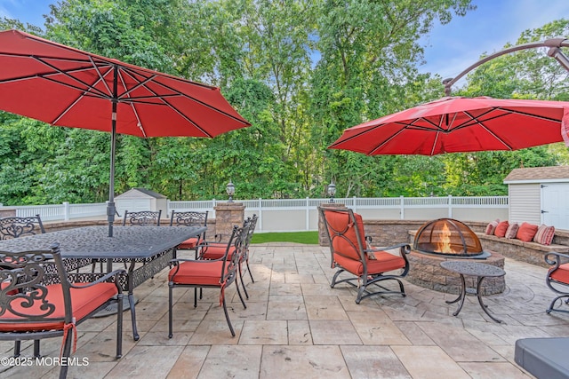 18 Pinewood Dr, Brick, NJ 08724 - fenced backyard featuring a storage unit, a fire pit, and a patio area
