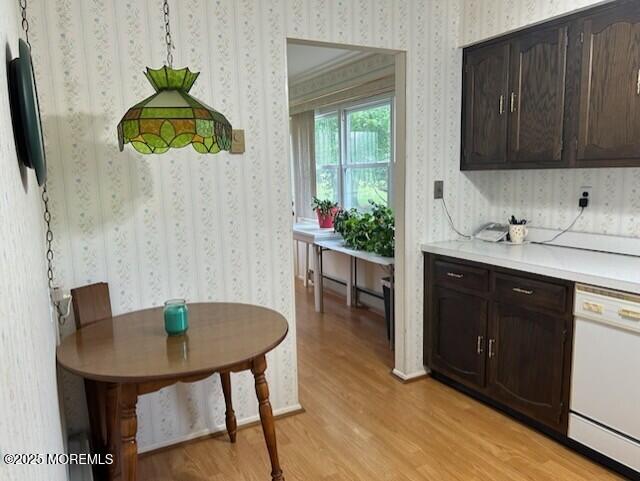 5 Lamb Rd, Brick, NJ 08724 - kitchen with white dishwasher, wallpapered walls, light wood-style flooring, light countertops, and dark brown cabinets