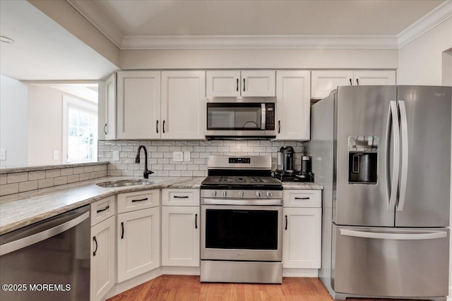 46 Sweet Gum Rd, Howell, NJ 07731 - kitchen featuring appliances with stainless steel finishes, ornamental molding, white cabinets, and backsplash