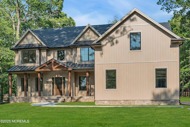 379 Buckalew Rd, Freehold, NJ 07728 - back of house featuring a standing seam roof, covered porch, a metal roof, and a lawn
