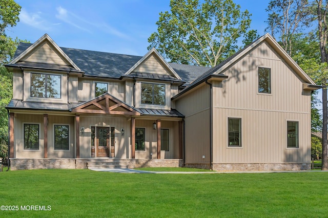 379 Buckalew Rd, Freehold, NJ 07728 - back of house with a porch, a standing seam roof, a lawn, and roof with shingles