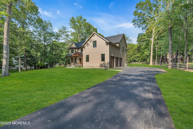 379 Buckalew Rd, Freehold, NJ 07728 - view of front of house featuring asphalt driveway, an attached garage, and view of scattered trees