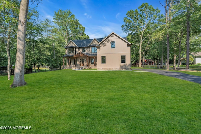 379 Buckalew Rd, Freehold, NJ 07728 - view of front of property with a standing seam roof, a balcony, a metal roof, and asphalt driveway