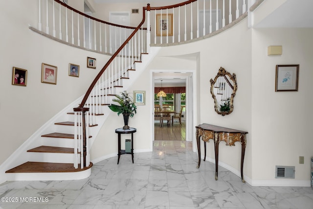 16 Chestnut Dr, Colts Neck, NJ 07722 - stairway featuring marble look tiles and a towering ceiling