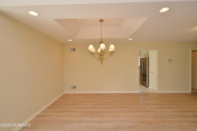3168 Wood Spring Ln, Toms River, NJ 08755 - empty room featuring a chandelier, light wood-type flooring, recessed lighting, and a raised ceiling