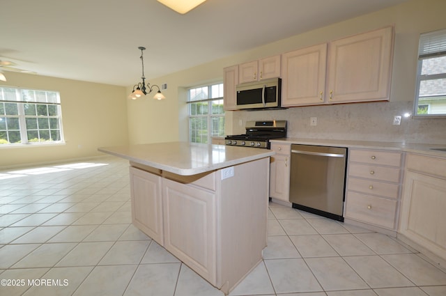 3168 Wood Spring Ln, Toms River, NJ 08755 - kitchen with appliances with stainless steel finishes, light tile patterned flooring, light countertops, backsplash, and a chandelier