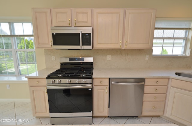 3168 Wood Spring Ln, Toms River, NJ 08755 - kitchen featuring stainless steel appliances, light tile patterned floors, light brown cabinets, light stone countertops, and backsplash