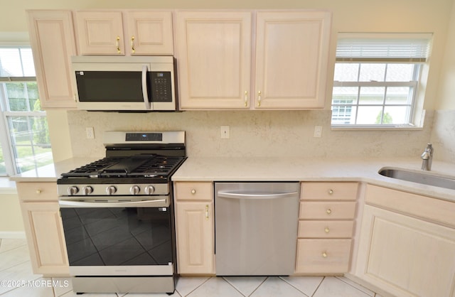 3168 Wood Spring Ln, Toms River, NJ 08755 - kitchen featuring appliances with stainless steel finishes, light tile patterned floors, tasteful backsplash, and light brown cabinetry