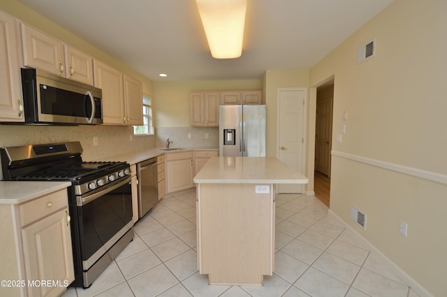 3168 Wood Spring Ln, Toms River, NJ 08755 - kitchen with appliances with stainless steel finishes, a center island, light countertops, backsplash, and light brown cabinets