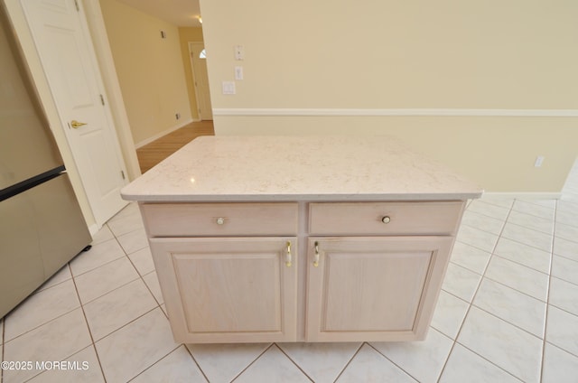 3168 Wood Spring Ln, Toms River, NJ 08755 - kitchen with freestanding refrigerator, light tile patterned flooring, light stone countertops, and a kitchen island