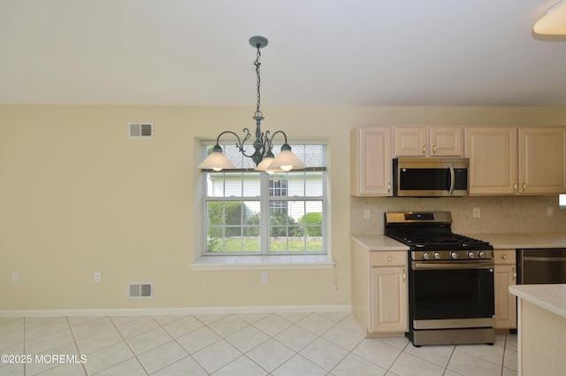 3168 Wood Spring Ln, Toms River, NJ 08755 - kitchen featuring appliances with stainless steel finishes, a chandelier, light countertops, light brown cabinets, and decorative backsplash