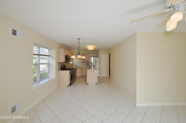 3168 Wood Spring Ln, Toms River, NJ 08755 - kitchen with stainless steel appliances, light tile patterned flooring, a center island, light countertops, and a chandelier