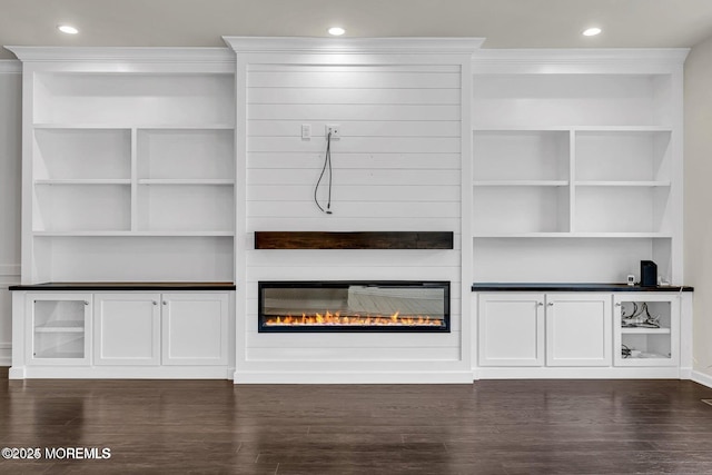 44 Begonia Ln, Monroe, NJ 08831 - unfurnished living room with a glass covered fireplace, dark wood-type flooring, recessed lighting, built in shelves, and ornamental molding