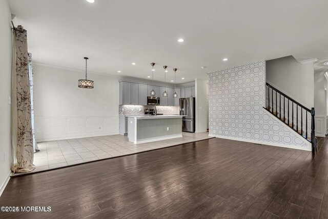 44 Begonia Ln, Monroe, NJ 08831 - unfurnished living room featuring ornamental molding, light wood-style floors, stairs, a wainscoted wall, and recessed lighting