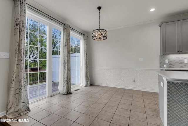 44 Begonia Ln, Monroe, NJ 08831 - unfurnished dining area with a chandelier, light tile patterned flooring, crown molding, and recessed lighting