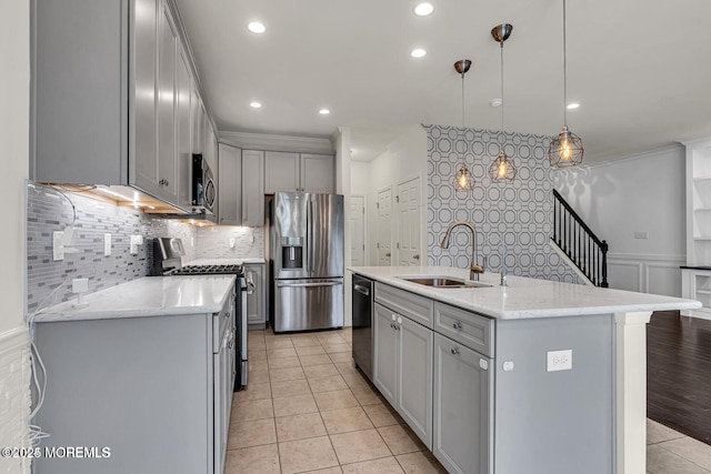 44 Begonia Ln, Monroe, NJ 08831 - kitchen featuring appliances with stainless steel finishes, gray cabinetry, decorative backsplash, light tile patterned floors, and a center island with sink
