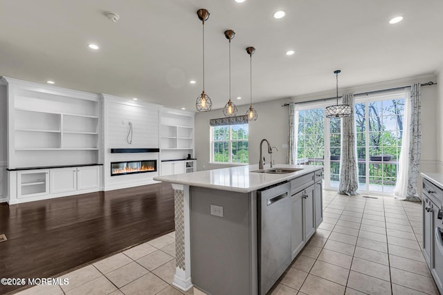 44 Begonia Ln, Monroe, NJ 08831 - kitchen featuring dishwasher, light countertops, an island with sink, light tile patterned flooring, and open shelves
