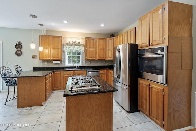 301 Cranberry Rd, Farmingdale, NJ 07727 - kitchen featuring stainless steel appliances, a peninsula, a breakfast bar area, tasteful backsplash, and a center island