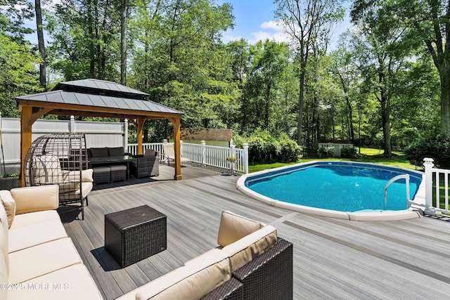 301 Cranberry Rd, Farmingdale, NJ 07727 - outdoor pool featuring an outdoor living space, a wooden deck, a gazebo, and view of scattered trees