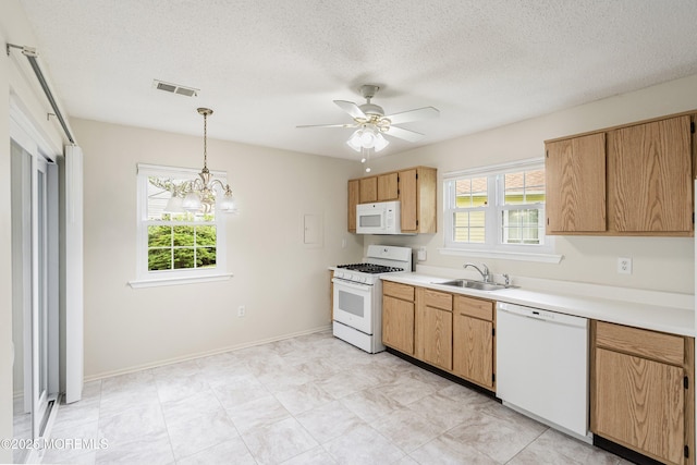 23 Datchet Close Unit 1000, Freehold, NJ 07728 - kitchen featuring white appliances, healthy amount of natural light, light countertops, ceiling fan, and a textured ceiling