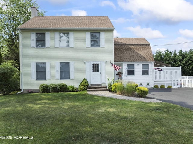 387 Barnegat Ln, Brick, NJ 08723 - view of front of home featuring a shingled roof, a chimney, and a front yard