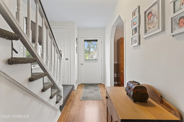 387 Barnegat Ln, Brick, NJ 08723 - entrance foyer with arched walkways, light wood-style flooring, and stairs