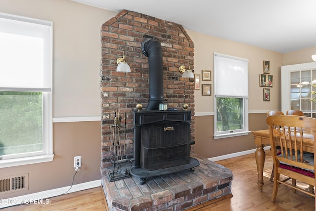 387 Barnegat Ln, Brick, NJ 08723 - living room featuring a wood stove, healthy amount of natural light, and wood finished floors