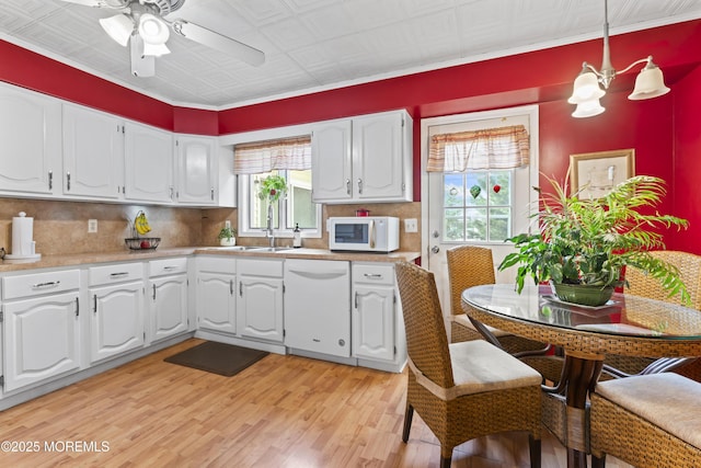 387 Barnegat Ln, Brick, NJ 08723 - kitchen with white appliances, white cabinets, light wood-style floors, backsplash, and an ornate ceiling