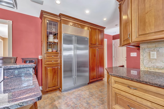 339 Ueland Rd, Red Bank, NJ 07701 - kitchen featuring built in fridge, dark stone counters, backsplash, glass insert cabinets, and recessed lighting