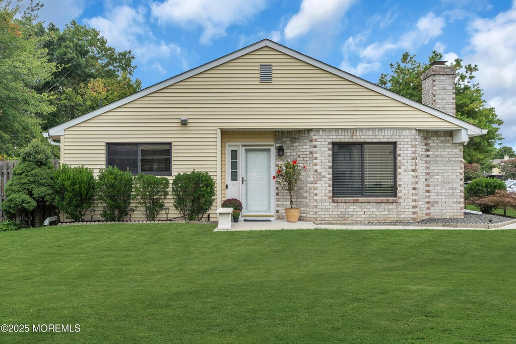 45 Victory Ct, Old Bridge, NJ 08857 - view of front of home featuring a chimney and a front yard