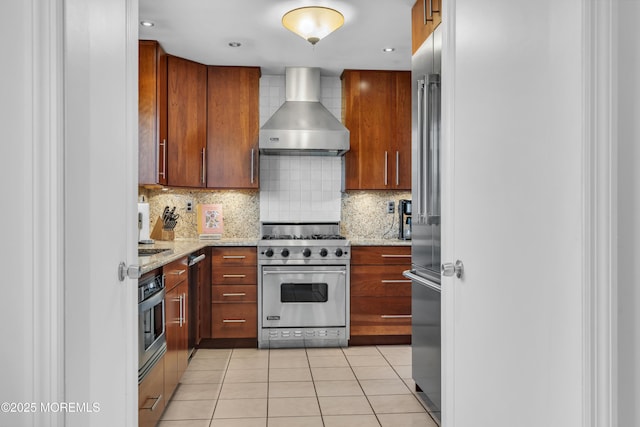 45 Victory Ct, Old Bridge, NJ 08857 - kitchen with wall chimney range hood, high quality appliances, backsplash, light tile patterned floors, and light stone counters